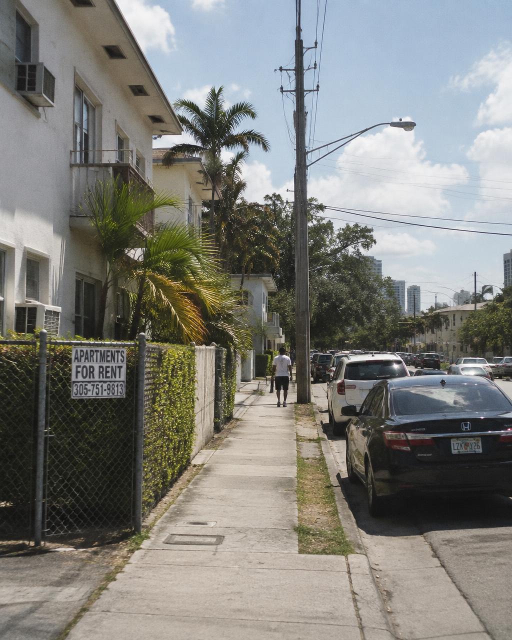 Adult in a bright Miami apartment joining a private telehealth visit on a tablet